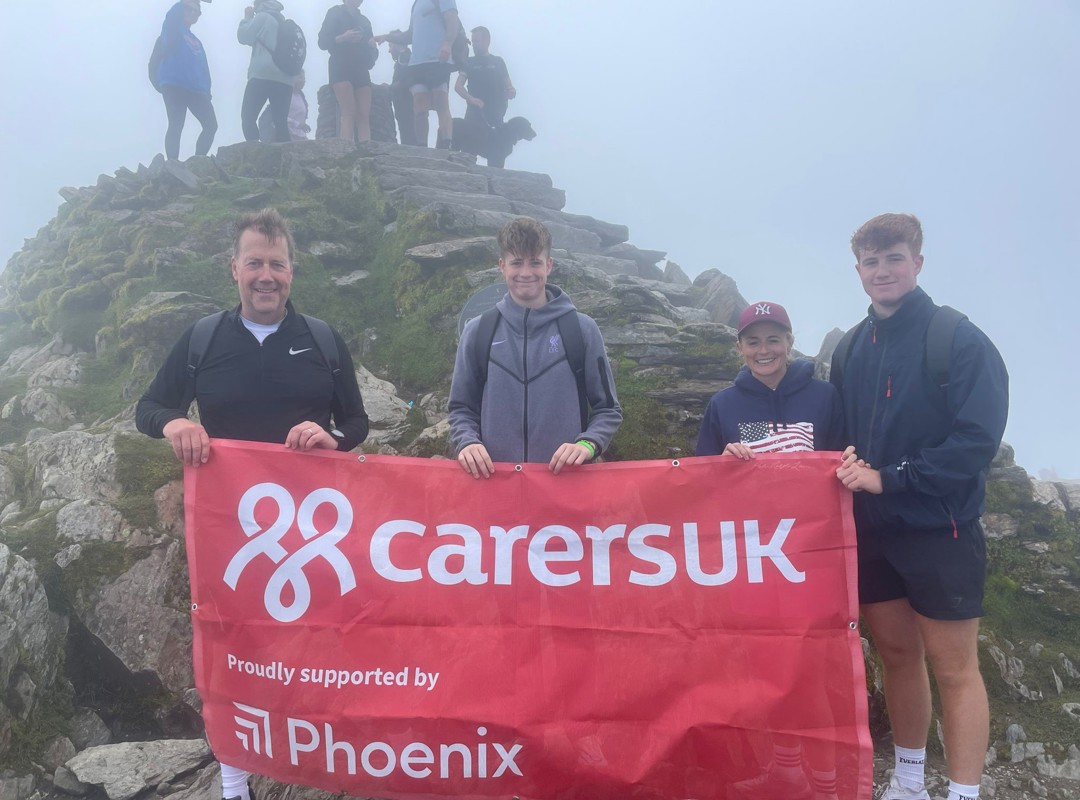 Andy Briggs And Family With Carers UK Flag At The Top Of Snowden