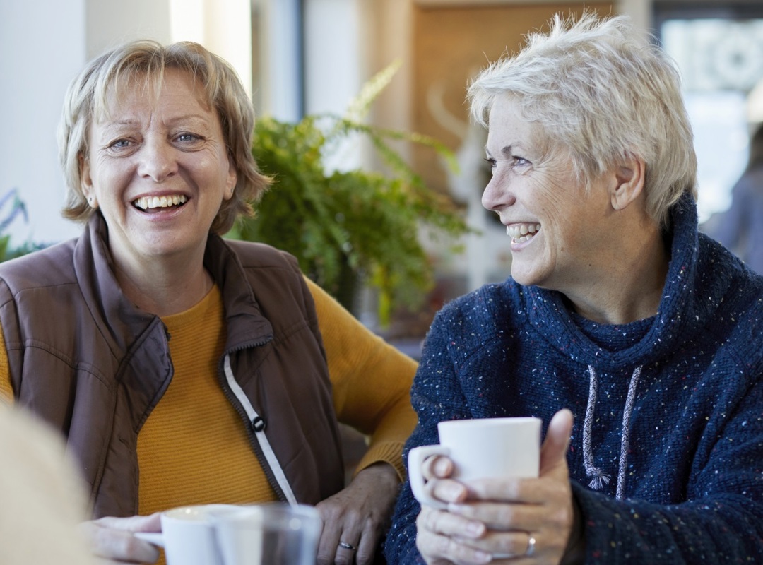 Women Sitting Having A Coffee