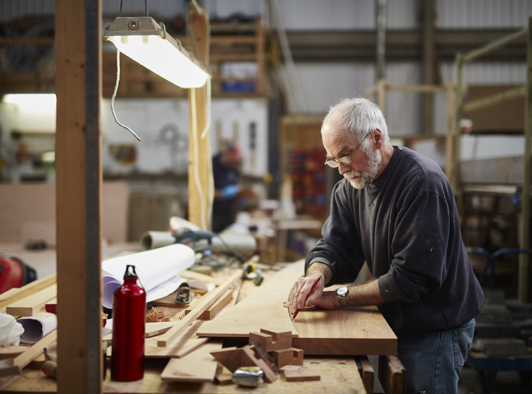 Person Measuring At A Workbench