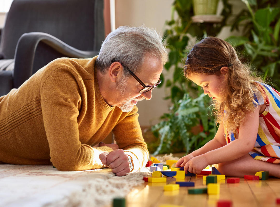 Grandfather And Grandaughter Playing Lego