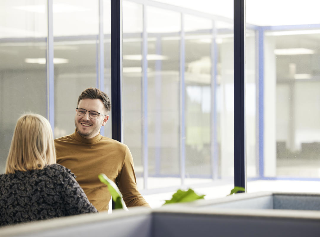 Two People Talking In The Office