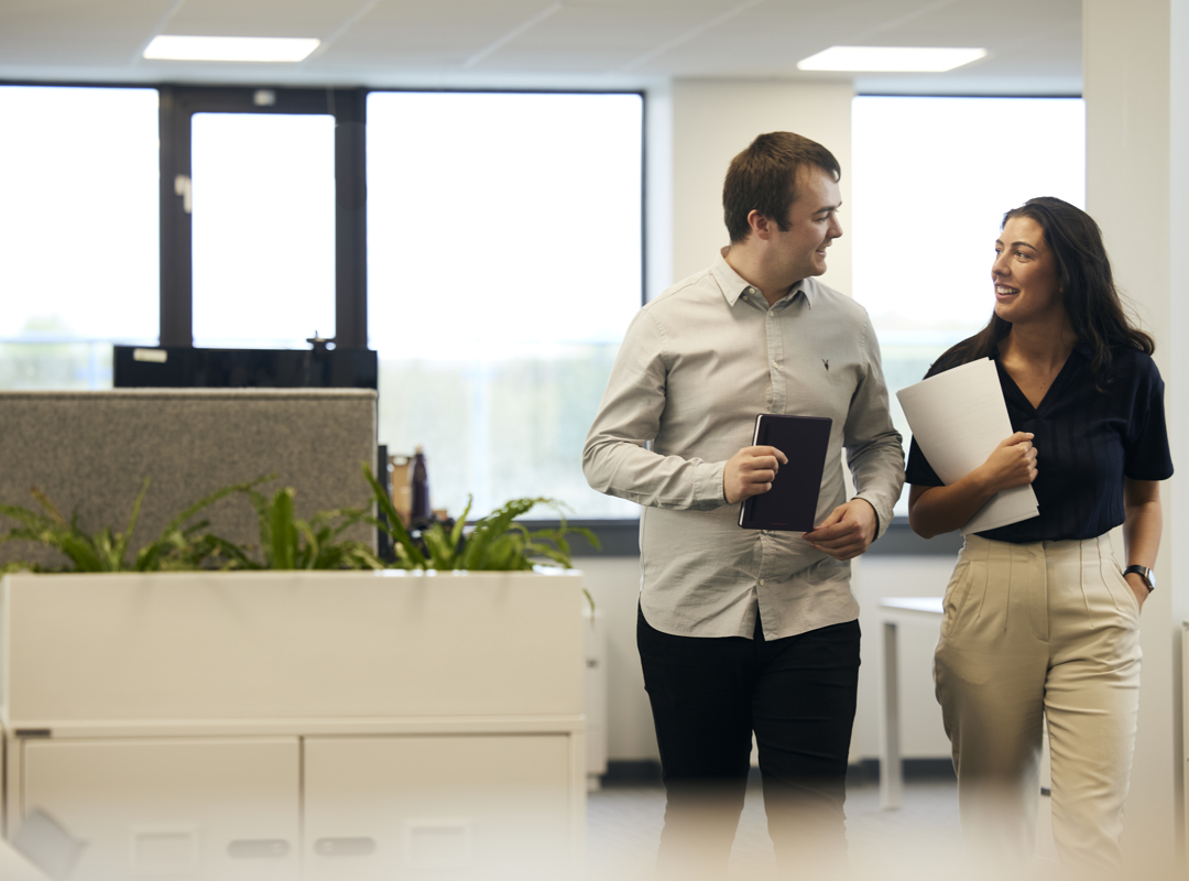 Two People Walking In The Office